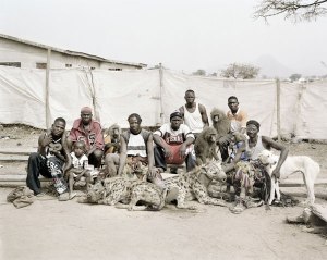 Men in Nigeria containing exotic animals such as: hyenas, pythons, and baboons.  Pieter Hugo. 2005-2007.
